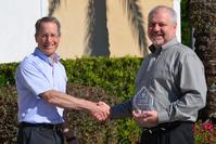 David Wolff, President of P. D. Circuits, awards EMC3 Group’s Mike Guild as Sales Person of the Year